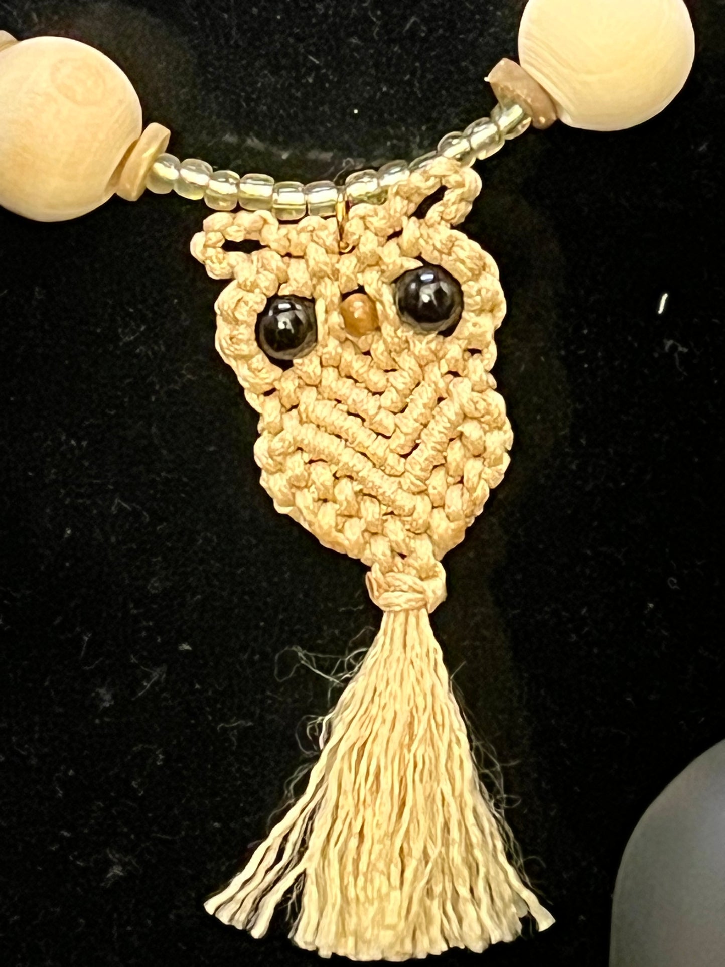 Close Up: Earth‑tone owl pendant necklace with natural wood beads