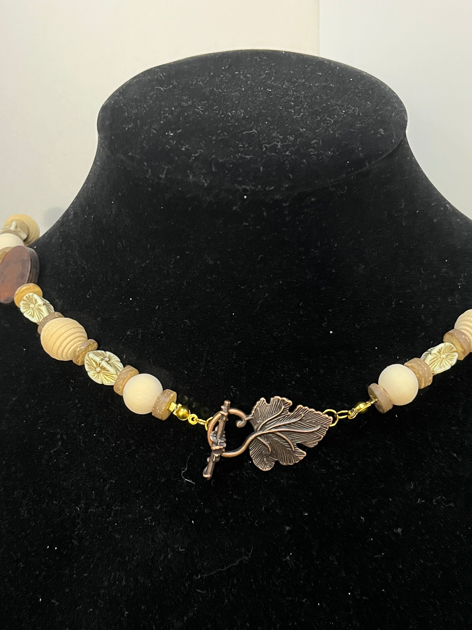 Close Up: Earth‑tone owl pendant necklace with natural wood beads