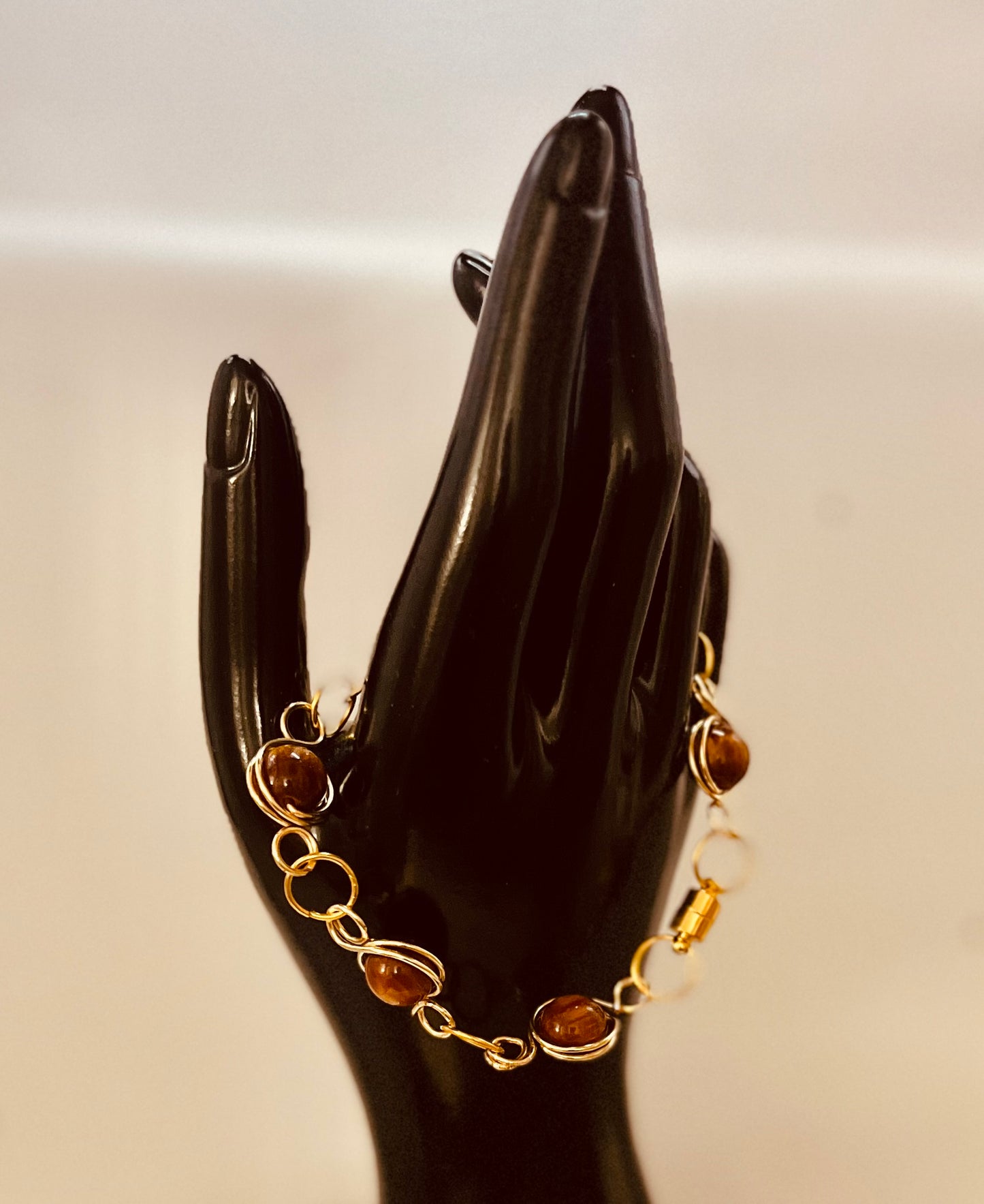 Close-up of matching gold chain bracelet with refined style