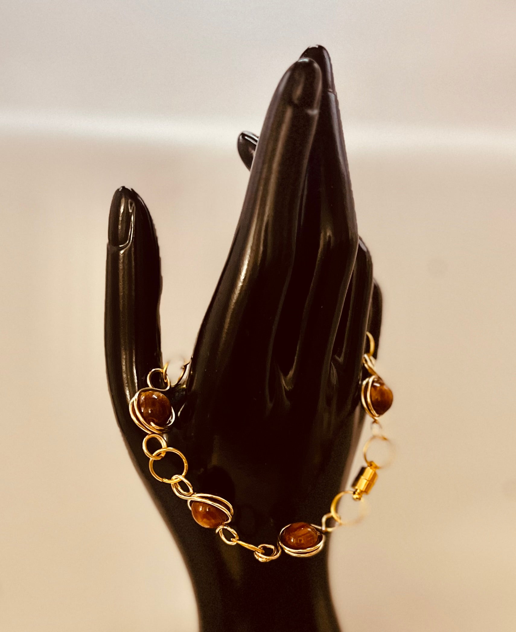 Close-up of matching gold chain bracelet with refined style