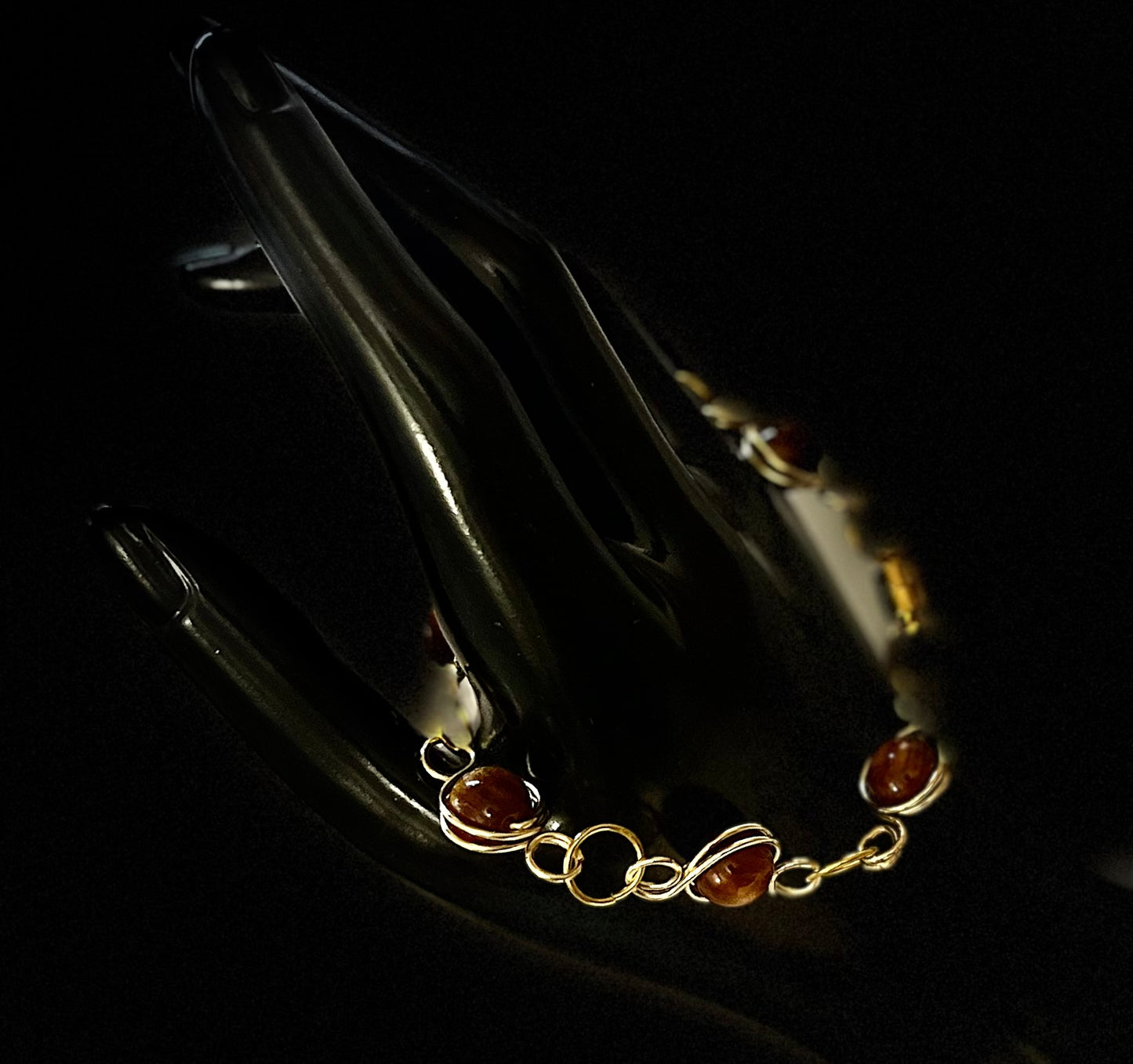 Close-up of matching gold chain bracelet with refined style