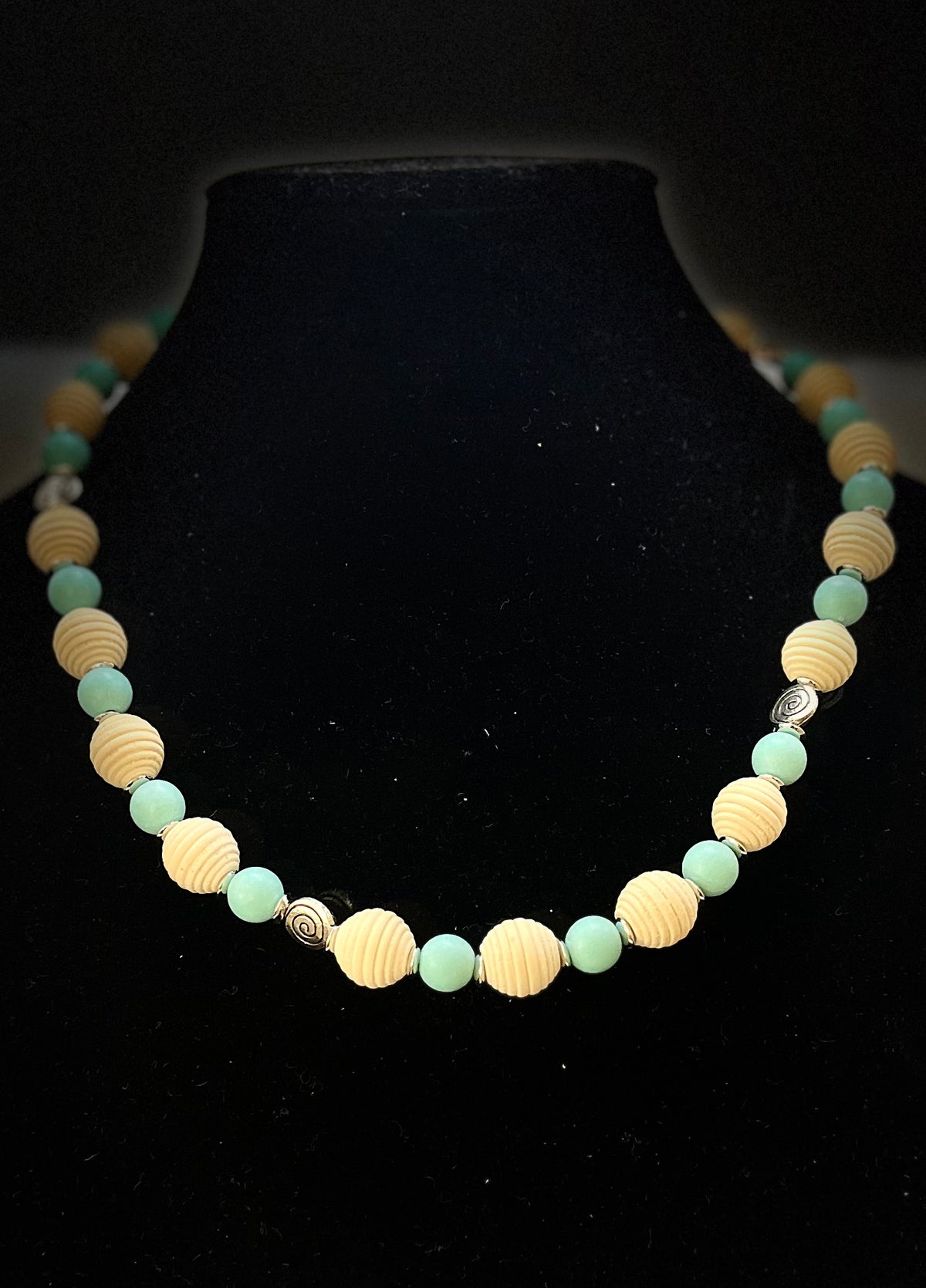 Close-up of Aqua and wood necklace styled for coastal fashion