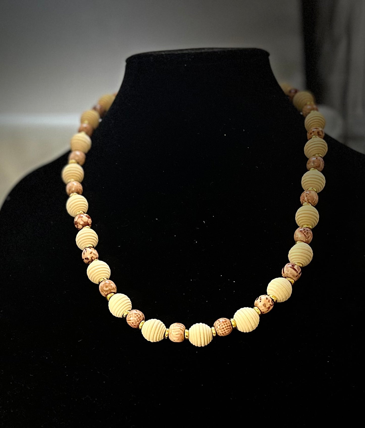 Close-up of wooden bead necklace with multiple shades of brown