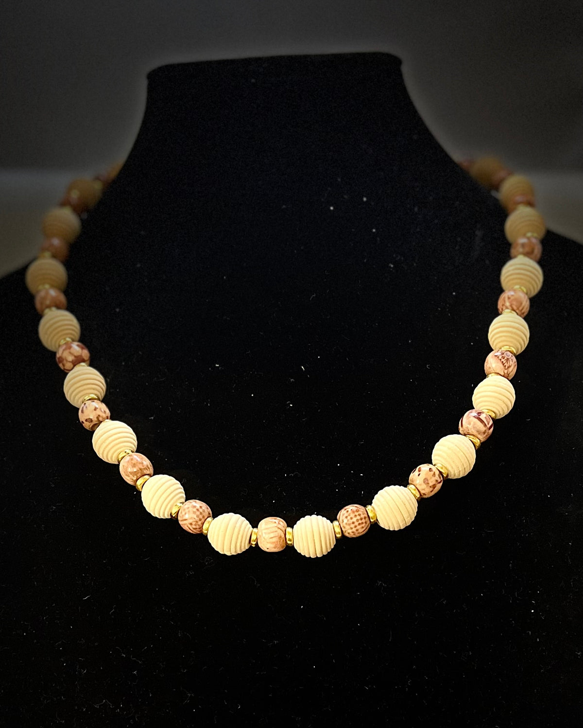 Close‑up of wooden jewelry necklace with earthy tones