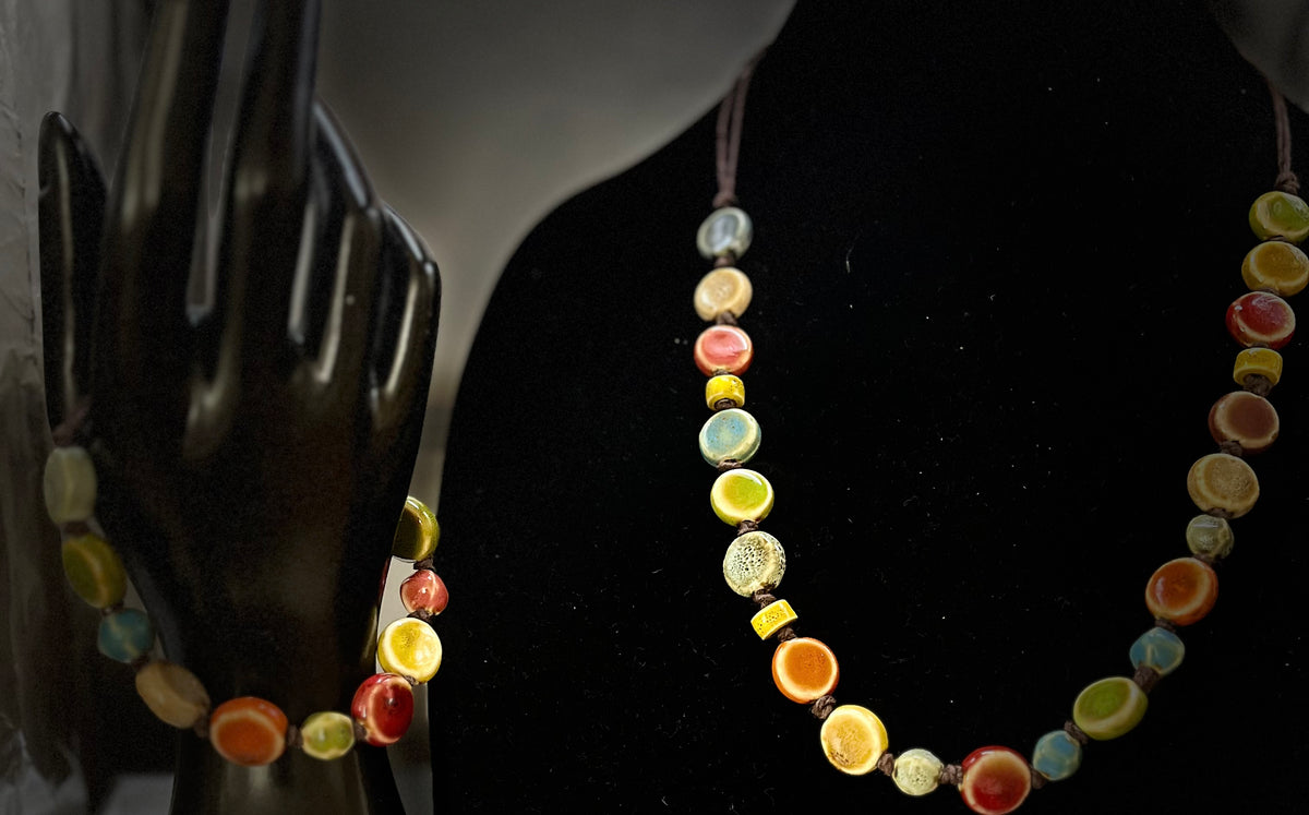 Handmade bohemian jewelry set displayed on neutral backdrop