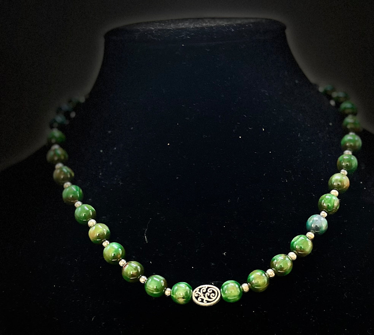 Green necklace styled for evening or formal wear