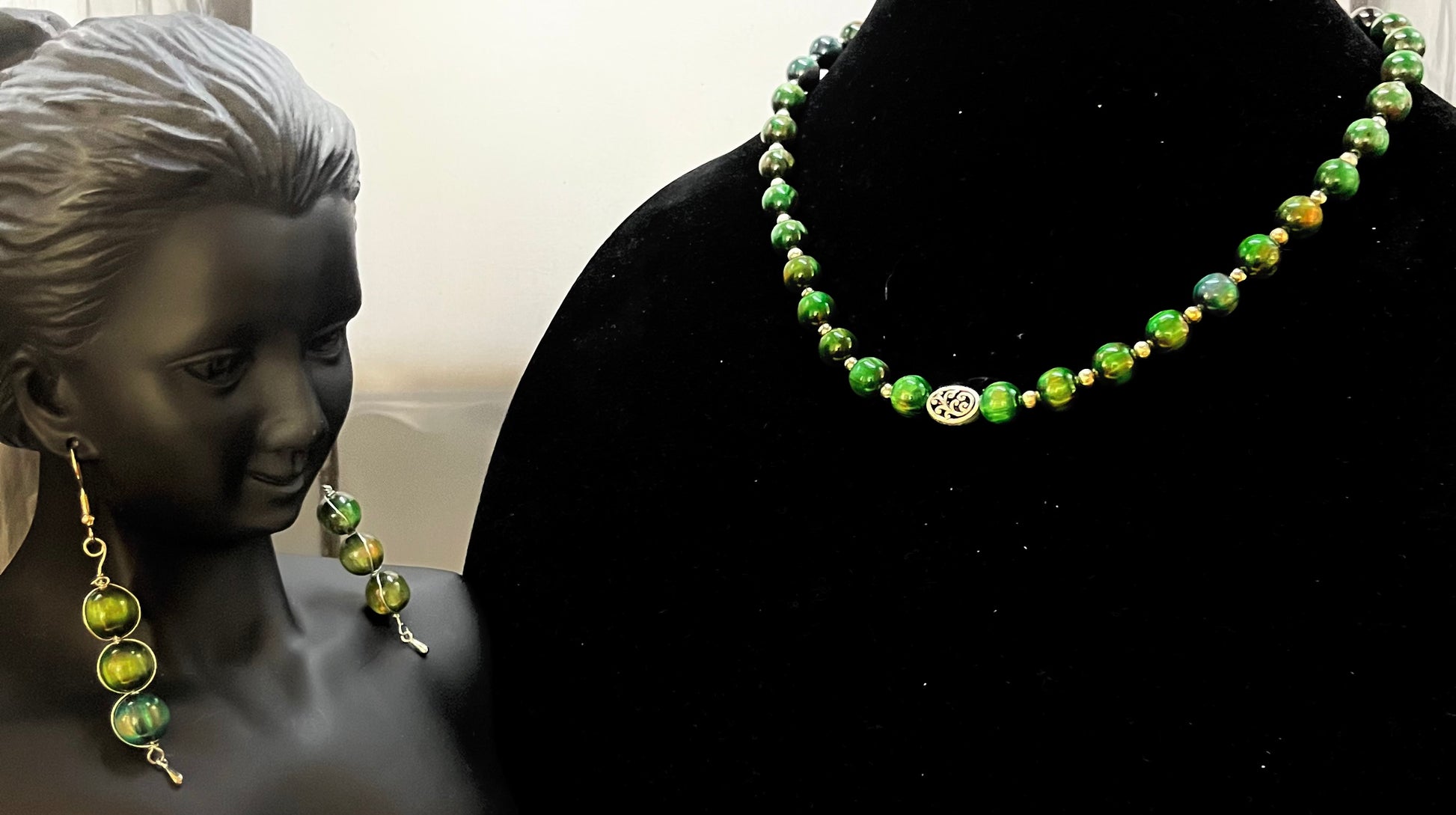 Full forest green jewelry set displayed on soft background
