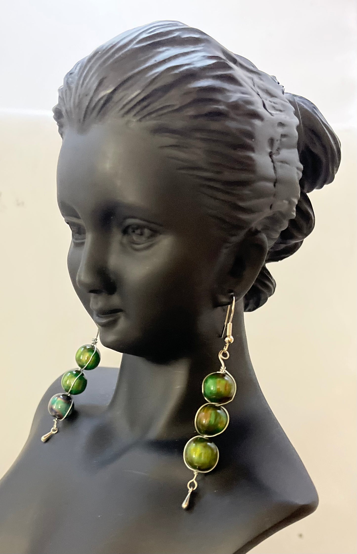 Matching green earrings with elegant beadwork