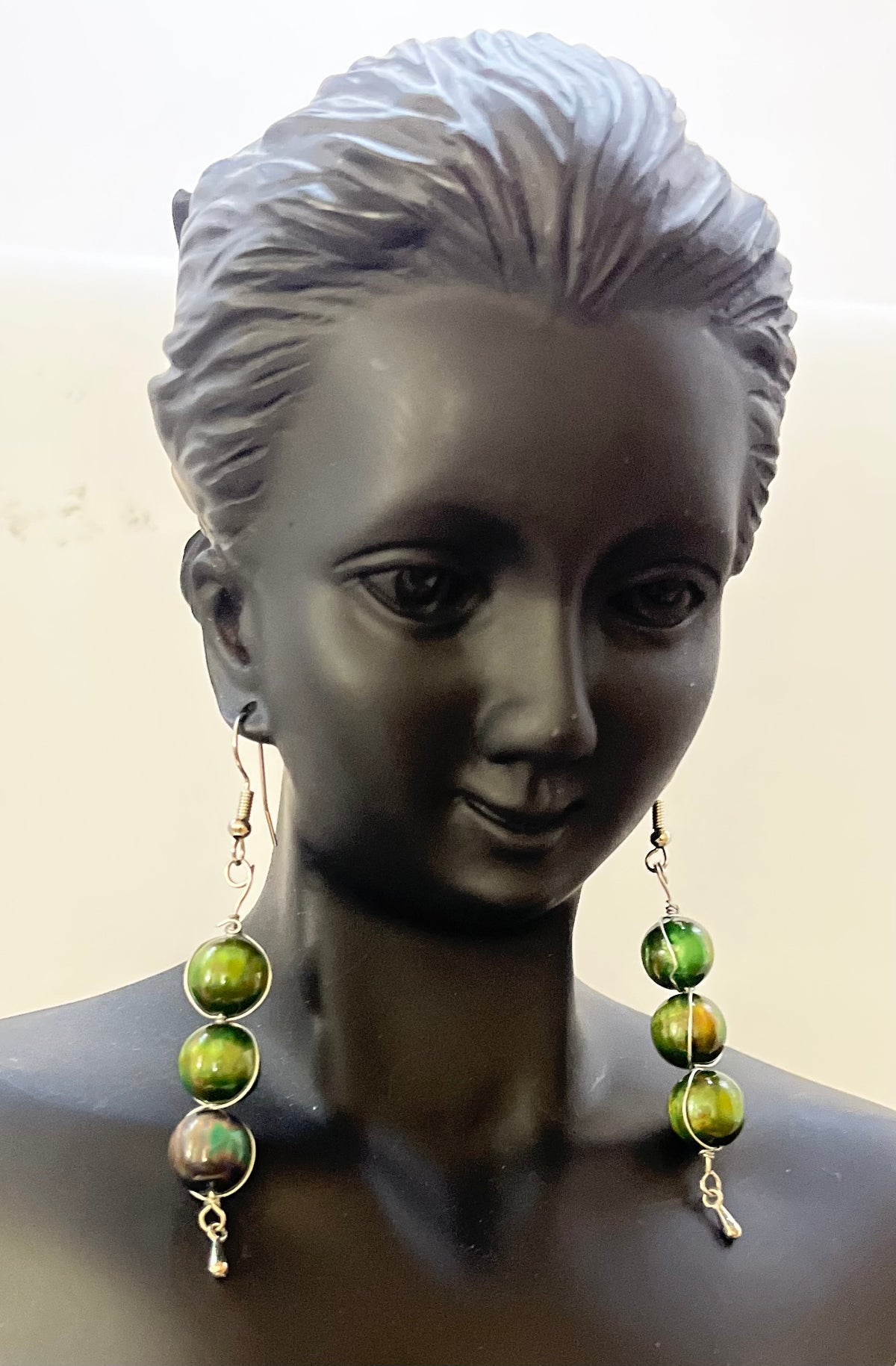 Matching green earrings with elegant beadwork