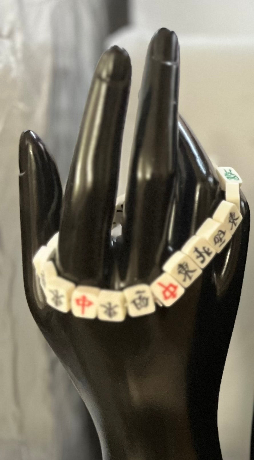 Close-up of Handcrafted Mahjong bracelet displayed on neutral background