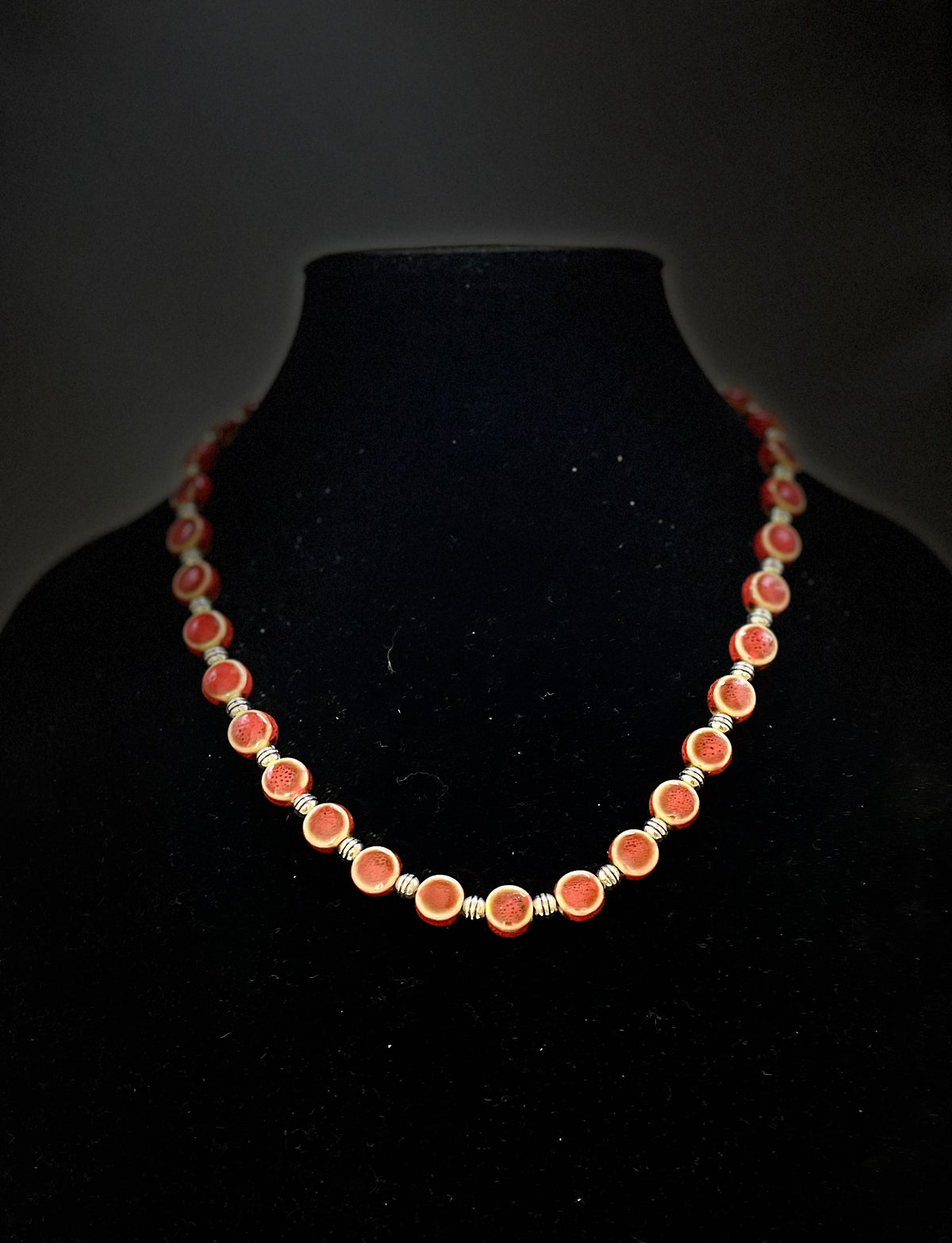 Close‑up of red ceramic jewelry set with vibrant shine