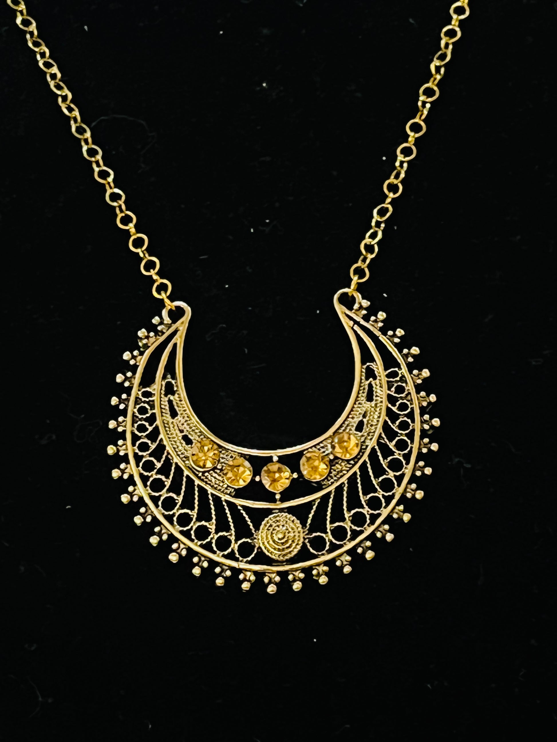 Close‑up of Egyptian goddess jewelry set with symbolic patterns