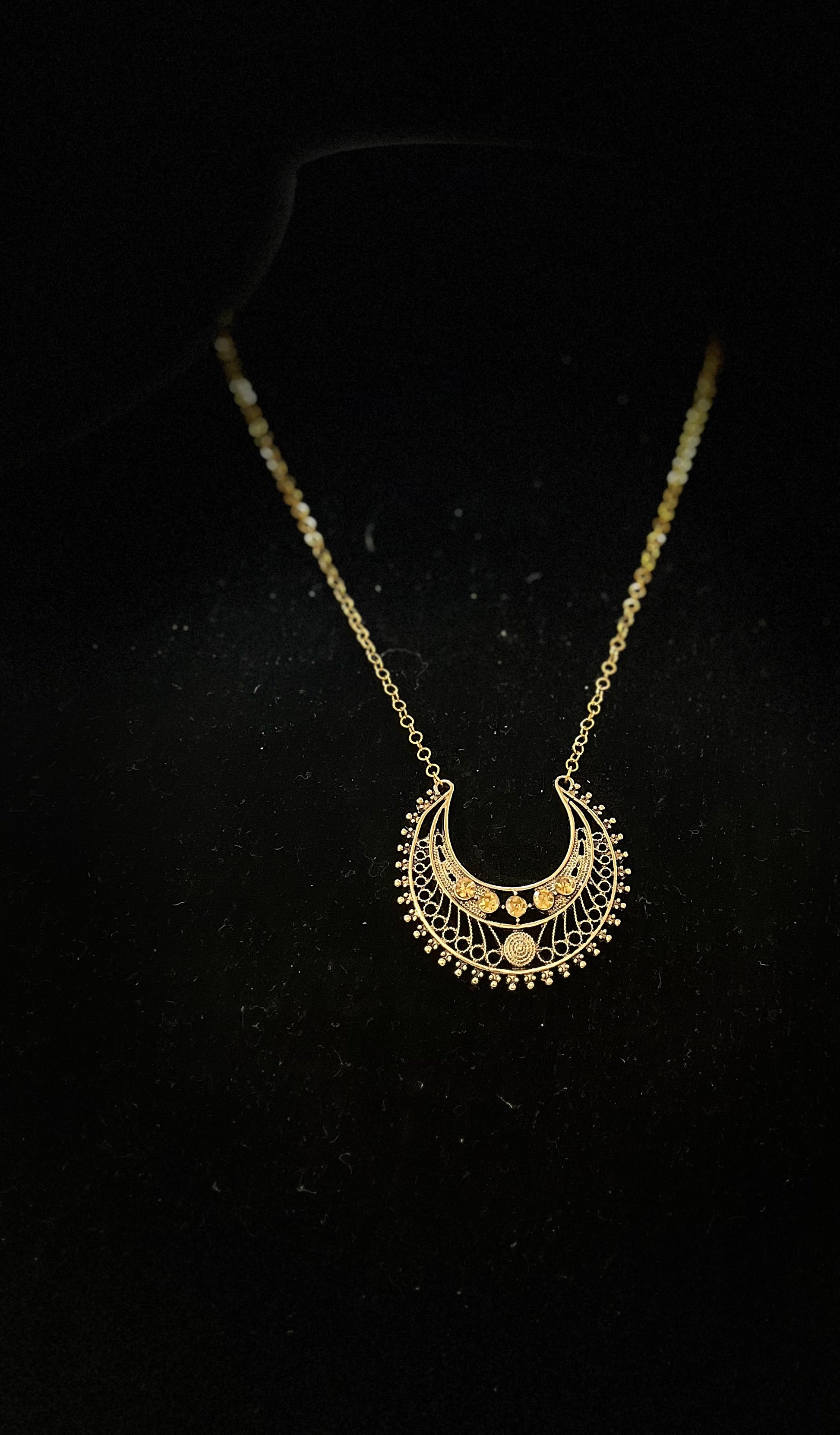Close‑up of Egyptian goddess jewelry set with symbolic patterns